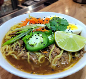 Noodle dish with beef, peppers served with lime and cilantro from Steller 181 Taphouse